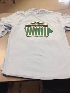 Iowa Philosophy Lyceum T Shirt 2014 - Previous Lyceum Logo on a Light Blue T Shirt